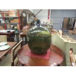 A large oversized green carboy, approx. 60cm tall