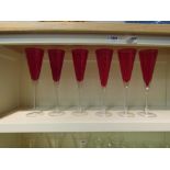 A set of six ruby & clear glass champagne flutes