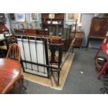 A Victorian brass and iron double bed frame with side irons and straps for base on ceramic castors