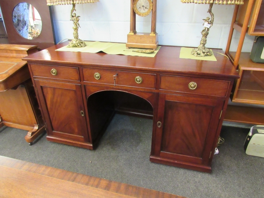 A 19th Century mahogany twin pedestal desk with modesty panel, the three frieze drawers over two