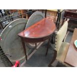 A 19th Century mahogany demilune card table, satinwood cross banded, square tapering legs to castors