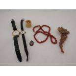 A carved bone ring, a coral coloured bead necklace, pendant and a bone carved brooch in the form