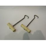 A pair of bone handled boot pullers