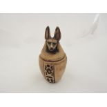 An alabaster Egyptian lidded jar with ancient pharaonic deity Anubis lid