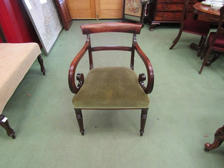 A George III circa 1820 mahogany scroll arm elbow chair with overstuffed sage coloured upholstered