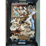 A box of trinkets/collector's cabinet items, including porcelain figures, shoes, miniature figures