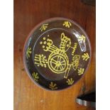 A Wetheriggs Penrith Pottery slipware dish with water wheel decoration 25cm diameter