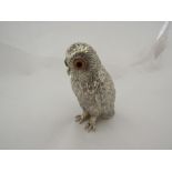 An owl form silver plated pepper pot with glass eyes marked Corbell & Co, Edinburgh, Scotland,