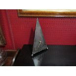 A metal timepiece of pyramid form, 27cm tall