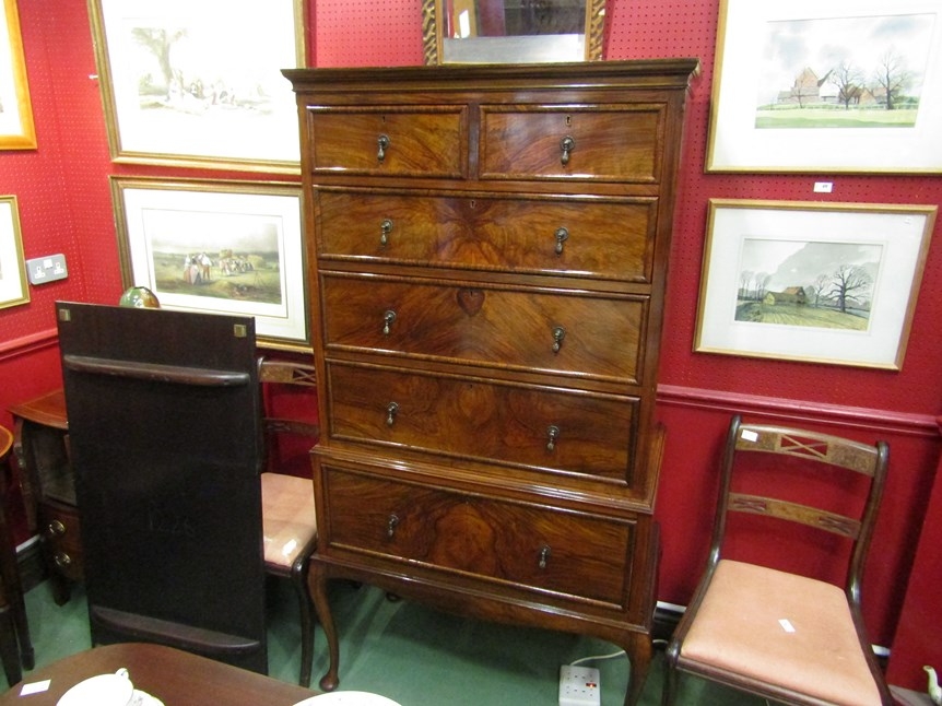 A George II revival figured walnut chest on stand of two short over four long drawers, with