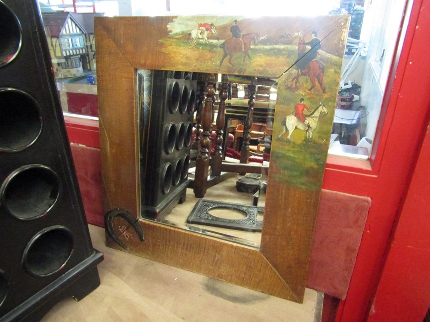 A bevel-edged rectangular wall mirror with wooden surrounded painted to depict fox hunting scenes