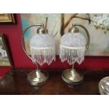 A pair of table lamps with mottled glass shade and beaded fringe