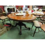 A circa 1860 burr walnut quarter veneer oval tilt top table on a turned and carved base with