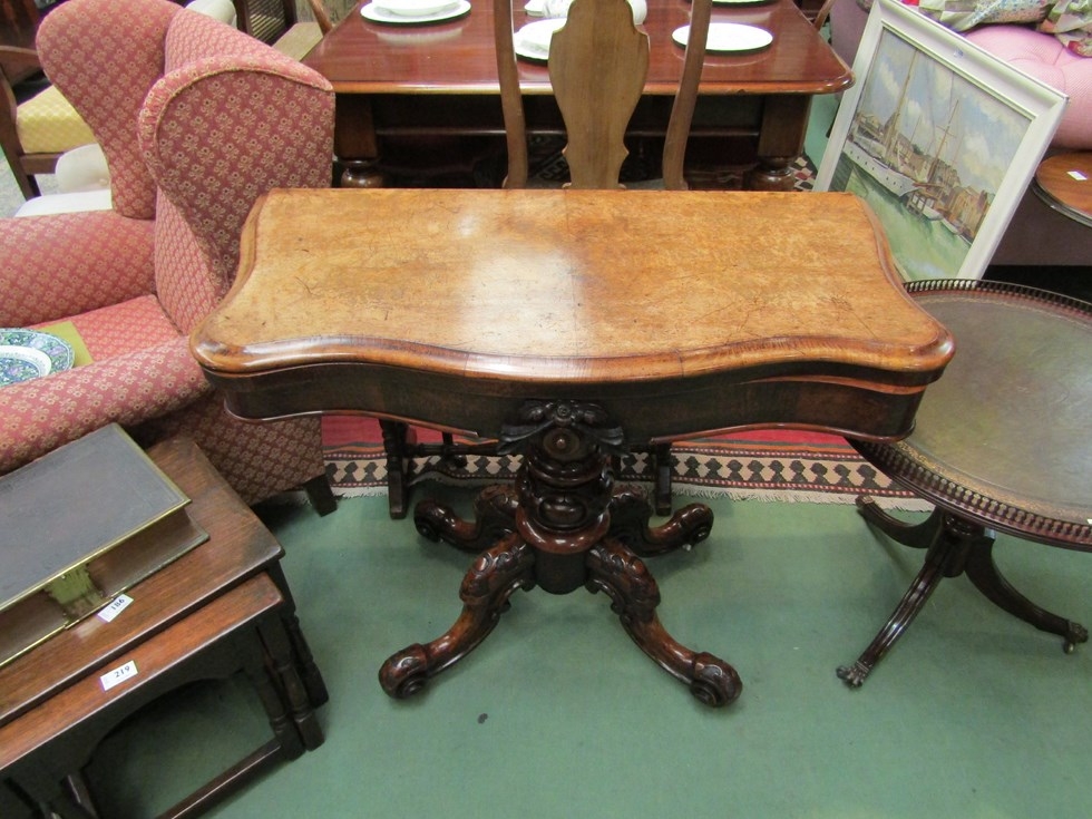 An early Victorian circa 1850 burr walnut serpentine front hinged top card table on a carved and