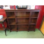 Circa 1900 an Arts and Crafts Oak nine division bookshelf with carved frieze over a reeded edge