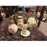 Three Ernst Wahliss vases and a posy vase depicting a figure of a girl clutching a shell, one