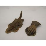 A Victorian embossed skirt lifter in the form of a hand, and a cast metal crocodile note holder (2)