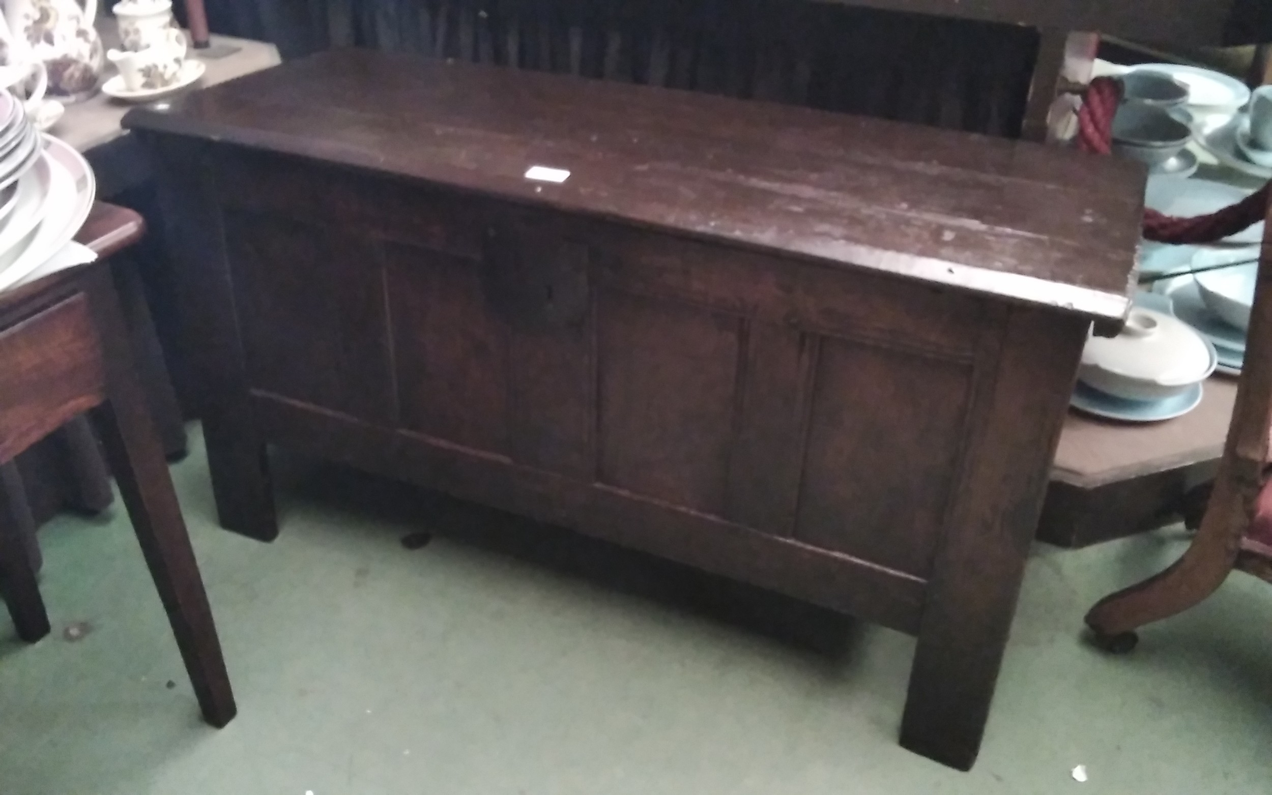 A 17th Century pegged oak coffer the split hinge top over a four panel base on stile feet, 108cm