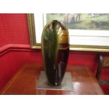 An Art glass vase in green and amber