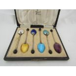 A cased set of six silver and enamel coffee spoons