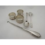 Three silver napkin rings, a button hook and two silver teaspoons