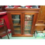 A mid Victorian walnut two door bookcase, plinth base, with key, 87cm wide x 31.5cm deep x 108.5cm