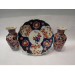 A pair of Chinese export vases painted in blue and red foliate detail, 22cm high, together with a