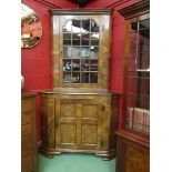 A George II revival burr walnut corner cabinet the panel glazed single door over a crossbanded