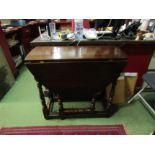 A circa 1800 oval top drop-leaf table with end drawer on turned supports joined by stretchers,