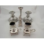 A pair of silver plated candlesticks, a vase and a collection of cruets