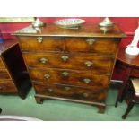 An 18th century walnut chest of two short over three long drawers with quarter veneer top and