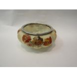 An early 20th century opaque glass bowl with handpainted floral detail, silver plated edge