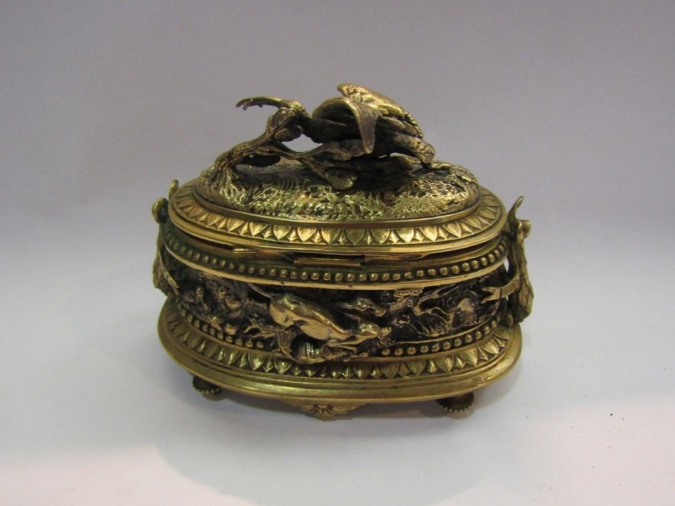 A cast brass lidded pot with hunting scenes of dogs chasing hares, a stork with fish etc. Signed - Image 2 of 4