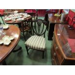 A pair of George III mahogany Hepplewhite chairs with carved harebell and pierced backrest on square