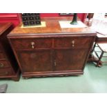 A figured walnut linen cabinet with carved decoration, the raised upstand over two drawers and two