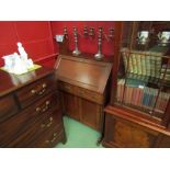 An Arts & Crafts walnut bureau the fall front with key and fitted shelf interior over two drawers