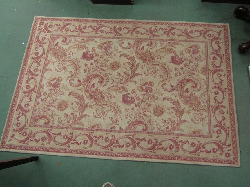 A Laura Ashley rug in yellow/beige and reds