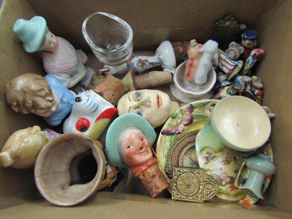 A collection of miniture items: A gully egg cup, bottle stoppers, doll's house items, miniture