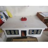 A dolls house bungalow, the roof lifting to reveal the interior, containing vintage tinplate and