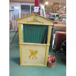 A wooden puppet theatre and five puppets