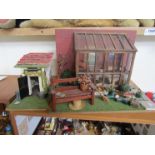 A dolls model greenhouse and outhouse with accessories