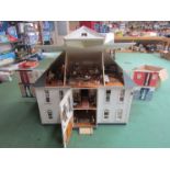 A large American kit built two storey dolls house with attic above, furnished with a good collection