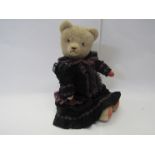 A 1940's straw filled pale blonde mohair jointed bear with pink pads, glass eyes, long upturned