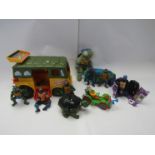 A collection of vintage playworn Teenage Mutant Ninja Turtles action figures and vehicles and a