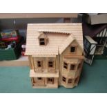 A wooden construction two storey dolls house with attic above