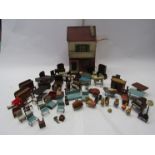 A vintage wooden two story dolls house with a quantity of dolls house funrniture and accessories