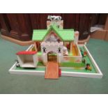 A wooden model fort and assorted plastic figures including Britain's together with a plastic farm
