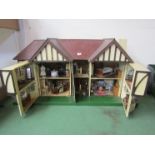 A large 1930's Tri-ang two storey dolls house with lighting, containing a collection of assorted