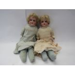 A pair of early 20th Century Armand Marseille 370 bisque head dolls in original pink and blue