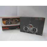 Two boxed Spektrum radio control aircraft systems to include DX6i and DX5E